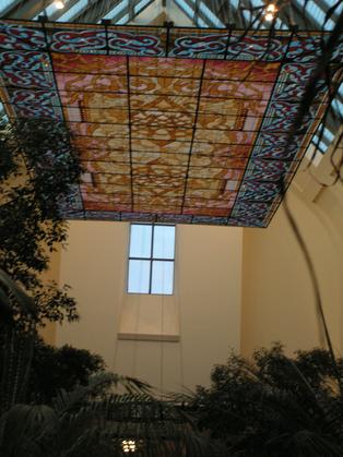 Lauritzen gardens hosted this display of the stained glass ceiling panel.  The open sunlight naturally lit the stained glass and its mirror image bounced back in the reflecting pool below. This Ceiling Panel measures approximately 20 feet by 40 feet.