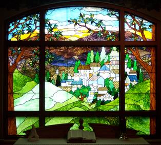"The Village" is an original stained glass panel which now resides in a hospital chapel window in Florida.