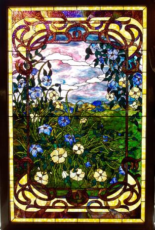 "A Spring Evening" is a lovely stained glass panel. Its colors and shading are notable. Much of the border is composed of Kokomo Catspaw granite, while the interior glass is mostly Youghiogheny ring mottles and stipple.