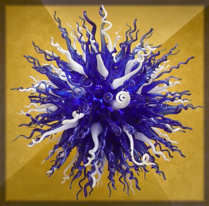 This is a blown glass Chandelier produced at our Spencer Studio.  This is "Cool Blue", approximately 5 foot in diameter and between 400 and 500 pounds.  This chandelier is comprised of approximately 240 individual blown glass pieces.  Other chandeliers with different coloring are also produced: "Sunburst", and "Cool Sunset".  Chandeliers can be custom made to range from two to six feet in diameter.